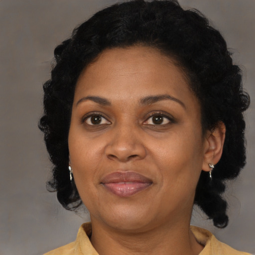 Joyful black adult female with short  black hair and brown eyes