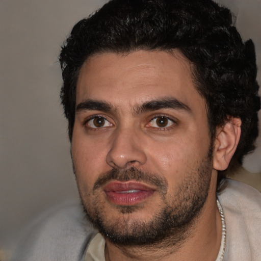 Joyful white young-adult male with short  black hair and brown eyes