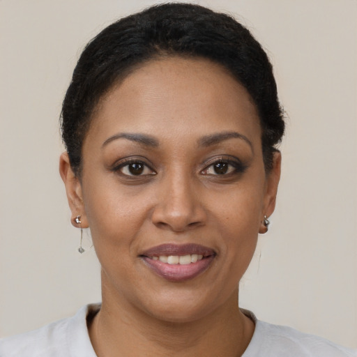 Joyful latino young-adult female with short  brown hair and brown eyes