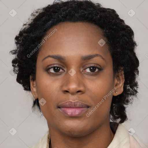 Joyful black adult female with long  brown hair and brown eyes