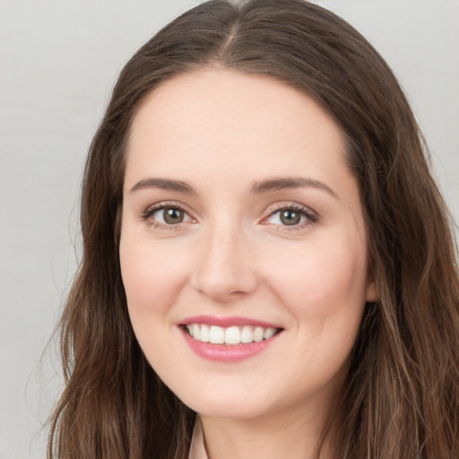 Joyful white young-adult female with long  brown hair and green eyes