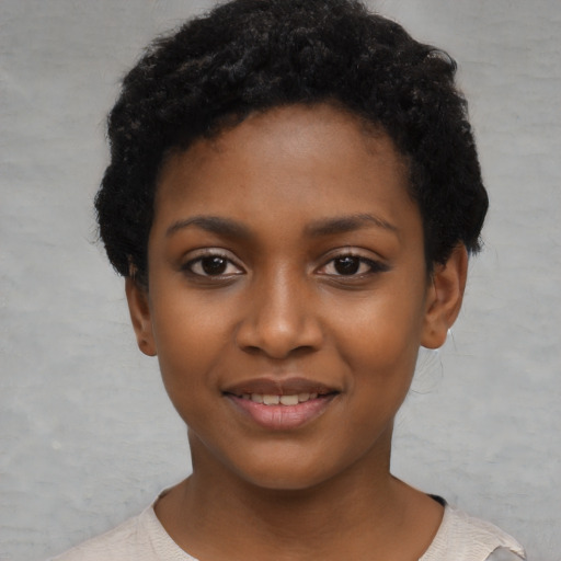 Joyful black child female with short  black hair and brown eyes