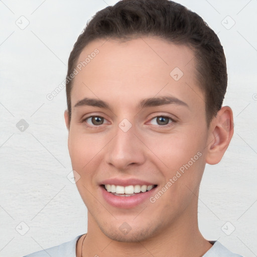 Joyful white young-adult male with short  brown hair and brown eyes