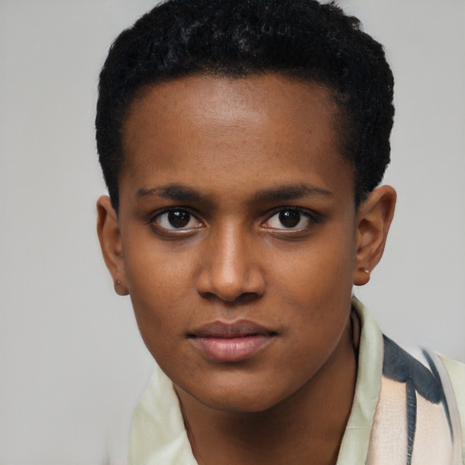 Joyful black young-adult female with short  black hair and brown eyes