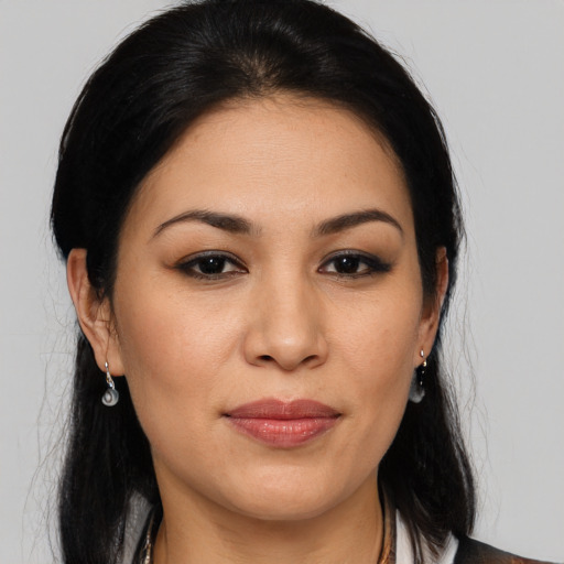 Joyful latino young-adult female with medium  brown hair and brown eyes