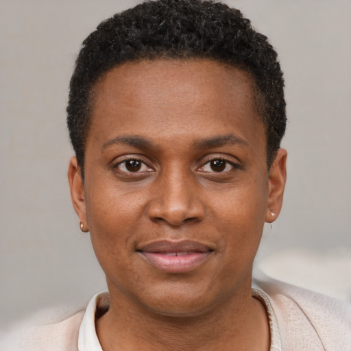 Joyful black young-adult male with short  brown hair and brown eyes