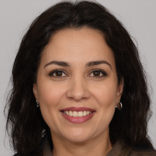 Joyful white adult female with long  brown hair and brown eyes