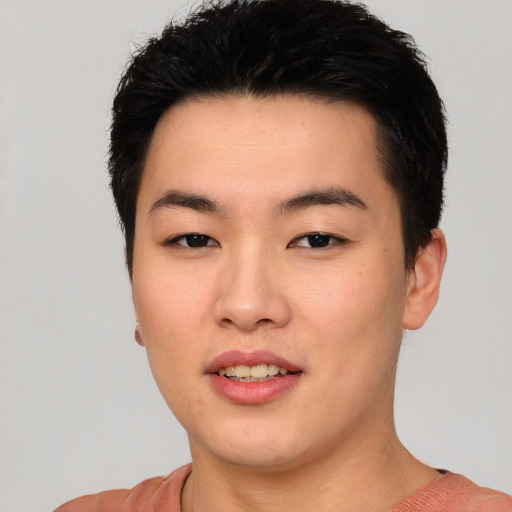 Joyful asian young-adult male with short  black hair and brown eyes