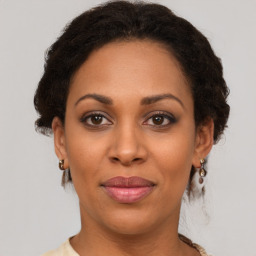 Joyful black young-adult female with short  brown hair and brown eyes