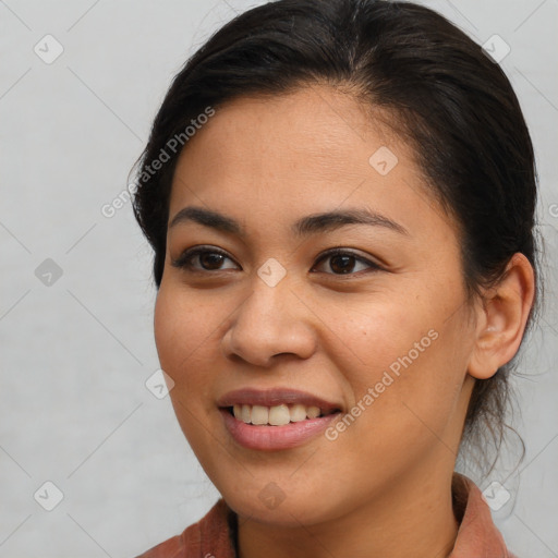 Joyful latino young-adult female with medium  brown hair and brown eyes