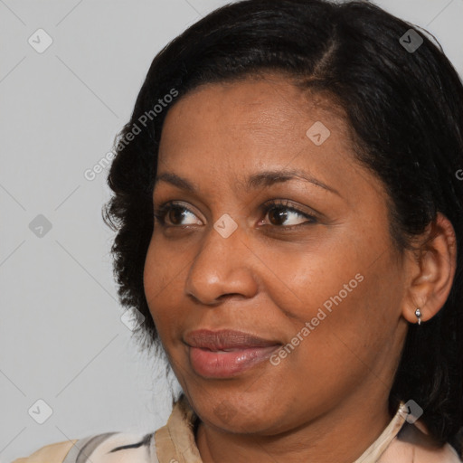 Joyful black adult female with medium  brown hair and brown eyes