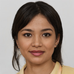 Joyful latino young-adult female with medium  brown hair and brown eyes