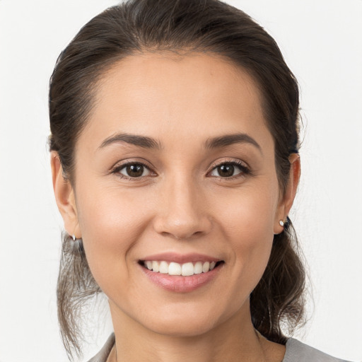 Joyful white young-adult female with medium  brown hair and brown eyes