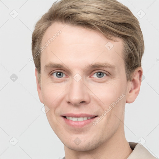 Joyful white young-adult male with short  brown hair and grey eyes