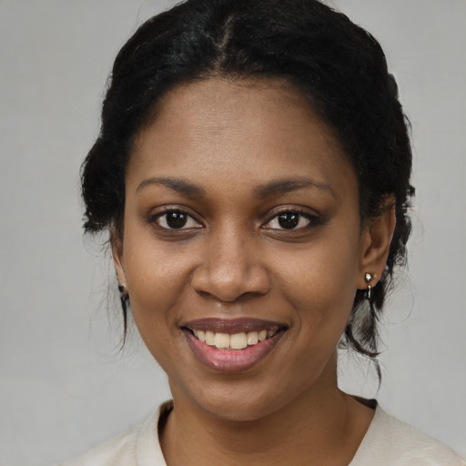 Joyful black young-adult female with medium  black hair and brown eyes