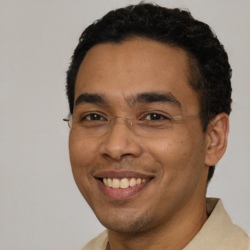 Joyful latino young-adult male with short  black hair and brown eyes