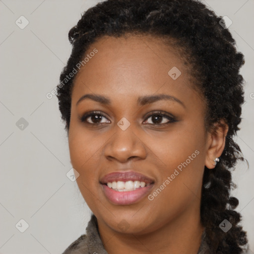 Joyful black young-adult female with long  black hair and brown eyes