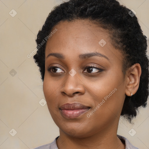 Joyful black young-adult female with medium  black hair and brown eyes