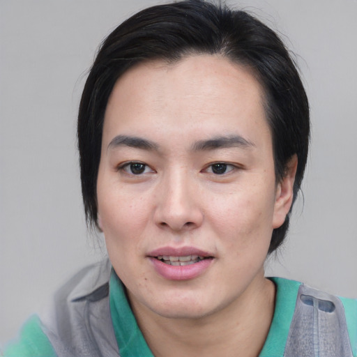 Joyful asian young-adult male with medium  black hair and brown eyes