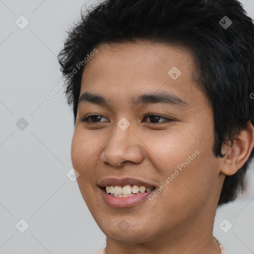 Joyful asian young-adult male with short  black hair and brown eyes