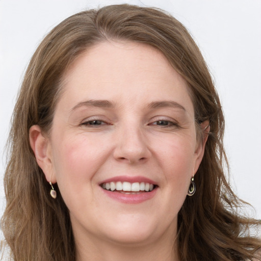 Joyful white young-adult female with long  brown hair and grey eyes