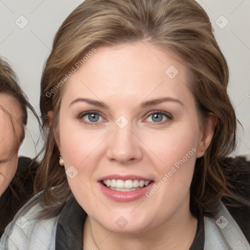 Joyful white young-adult female with medium  brown hair and blue eyes