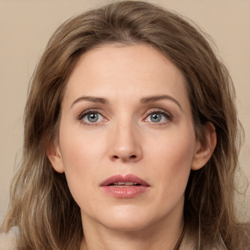 Joyful white young-adult female with long  brown hair and grey eyes