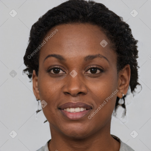 Joyful black adult female with short  brown hair and brown eyes