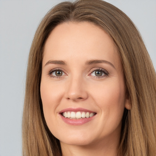 Joyful white young-adult female with long  brown hair and brown eyes