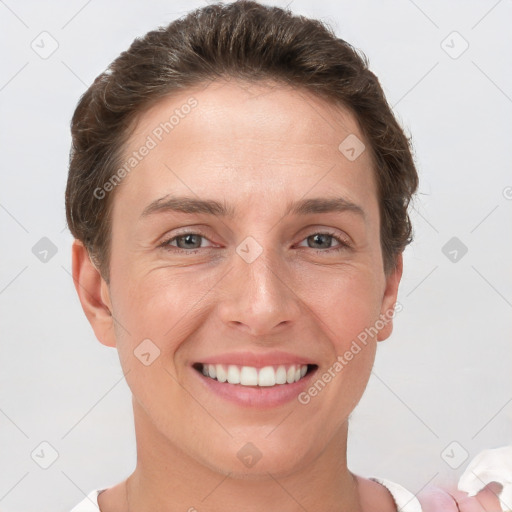 Joyful white young-adult female with short  brown hair and grey eyes