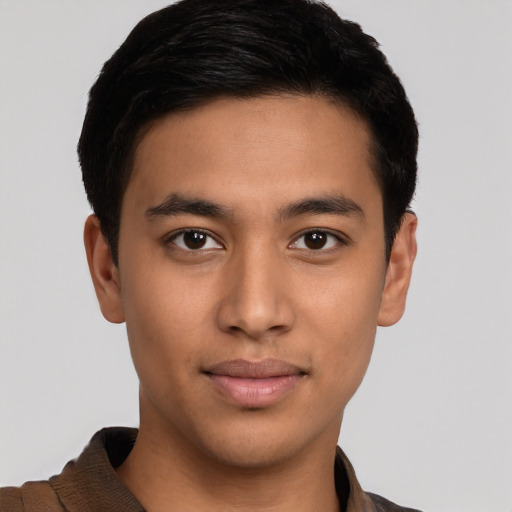 Joyful latino young-adult male with short  brown hair and brown eyes
