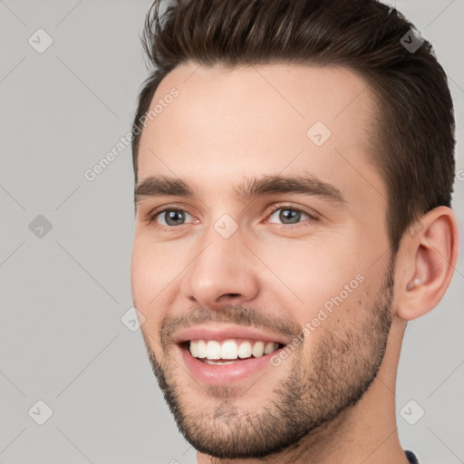 Joyful white young-adult male with short  brown hair and brown eyes