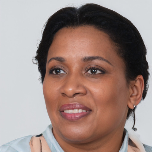 Joyful black adult female with short  brown hair and brown eyes
