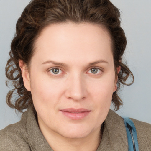 Joyful white young-adult female with medium  brown hair and blue eyes