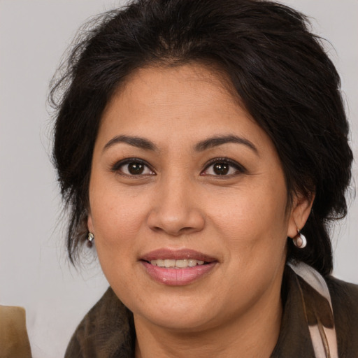 Joyful asian adult female with medium  brown hair and brown eyes