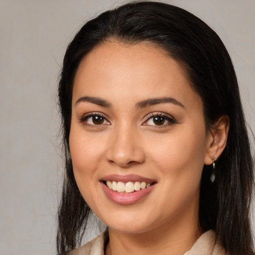 Joyful latino young-adult female with long  brown hair and brown eyes