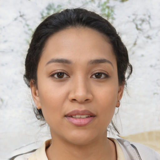 Joyful latino young-adult female with medium  brown hair and brown eyes