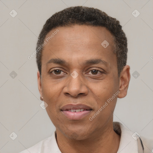 Joyful black adult male with short  black hair and brown eyes