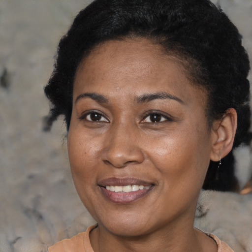 Joyful black young-adult female with short  brown hair and brown eyes
