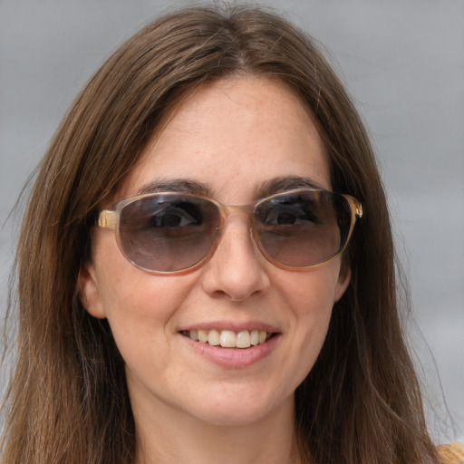 Joyful white young-adult female with long  brown hair and blue eyes