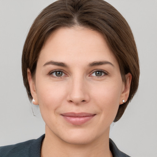 Joyful white young-adult female with medium  brown hair and grey eyes