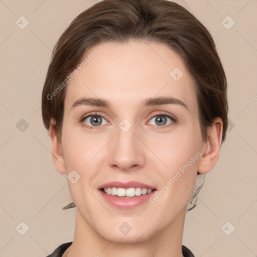 Joyful white young-adult female with short  brown hair and grey eyes