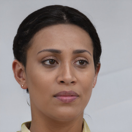 Joyful latino young-adult female with short  brown hair and brown eyes