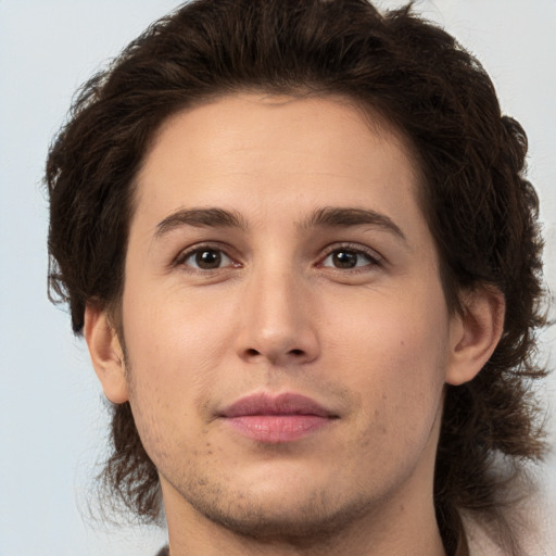 Joyful white young-adult male with medium  brown hair and brown eyes