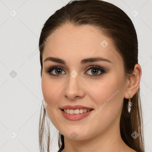 Joyful white young-adult female with long  brown hair and brown eyes