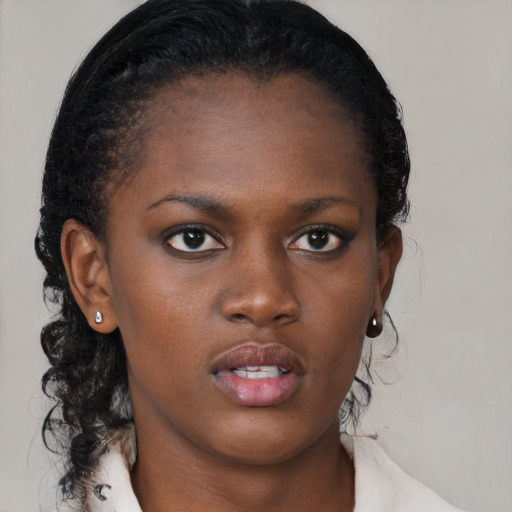 Neutral black young-adult female with medium  brown hair and brown eyes
