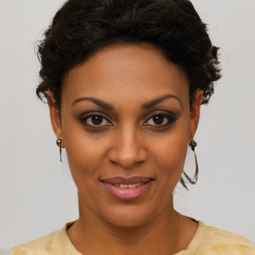 Joyful black young-adult female with short  brown hair and brown eyes