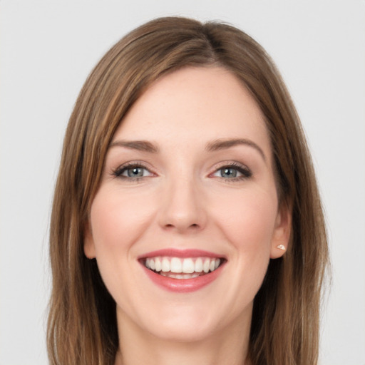 Joyful white young-adult female with long  brown hair and green eyes