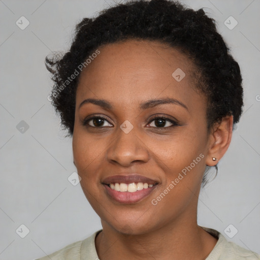 Joyful black young-adult female with short  brown hair and brown eyes