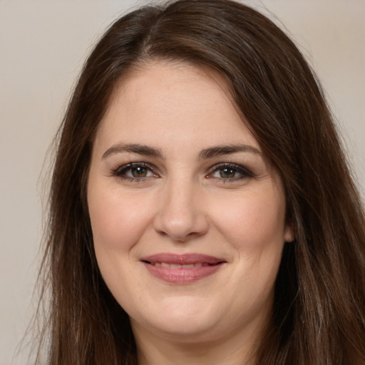 Joyful white young-adult female with long  brown hair and brown eyes